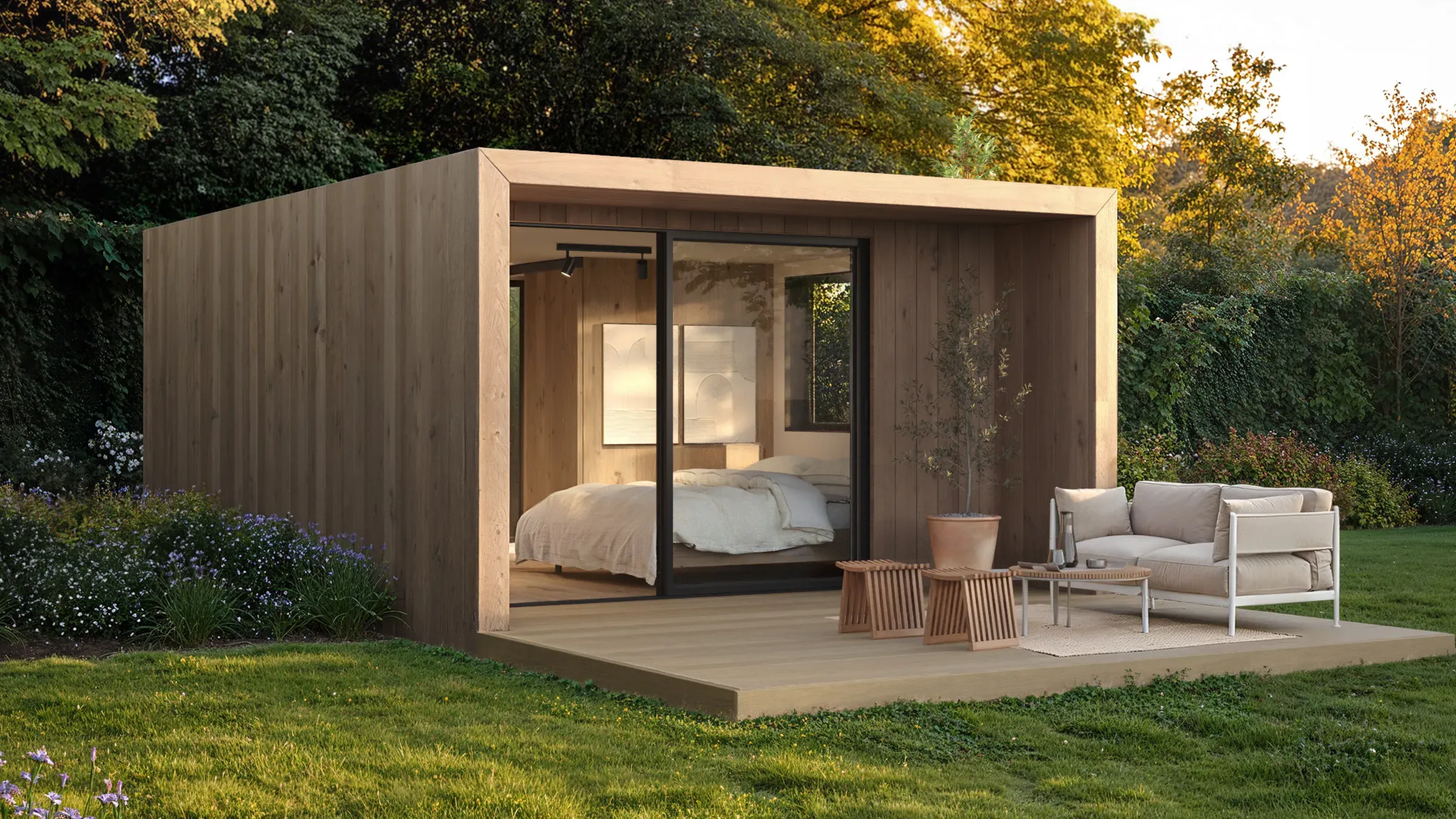 Factory-finished NOOK guest suite lit from within at dusk on open land — road-legal modular hospitality cabin. Visualization.